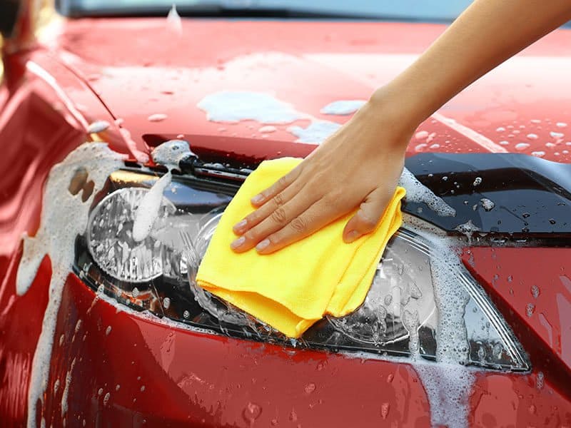 Servicewoman Washing Car